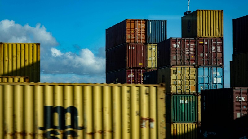 A vibrant display of stacked cargo containers against a clear blue sky., tags: dokwerkers de - pexel