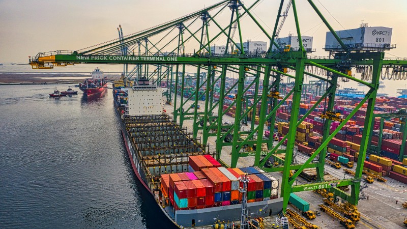 Aerial view of a cargo ship docked at New Priok Container Terminal, Jakarta, showcasing vibrant logistics activity., tags: van - pexel